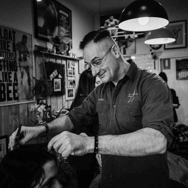 Senior barber Daniel cutting hair inside the classic Barber on Hutt Street shop in Adelaide.